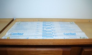 Cover The Open Part Above Your Kitchen Cabinets with Contact Paper for Easy Cleaning